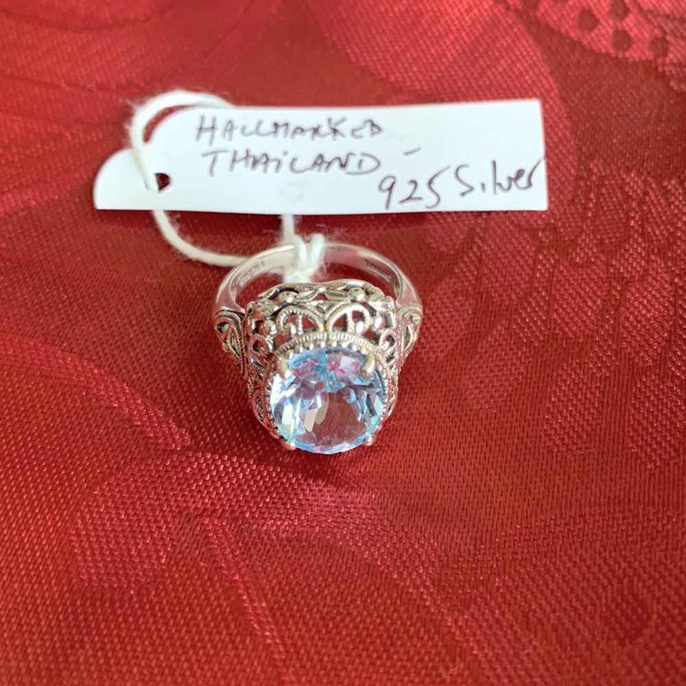 Blue topaz and 925 Silver ring. Beautiful style and design around stone